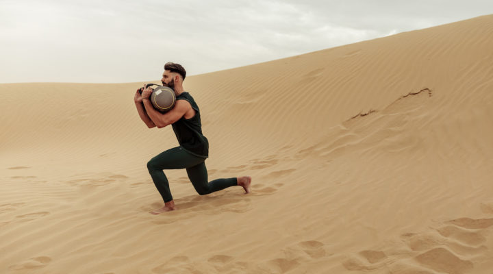 man completing sandbag workout